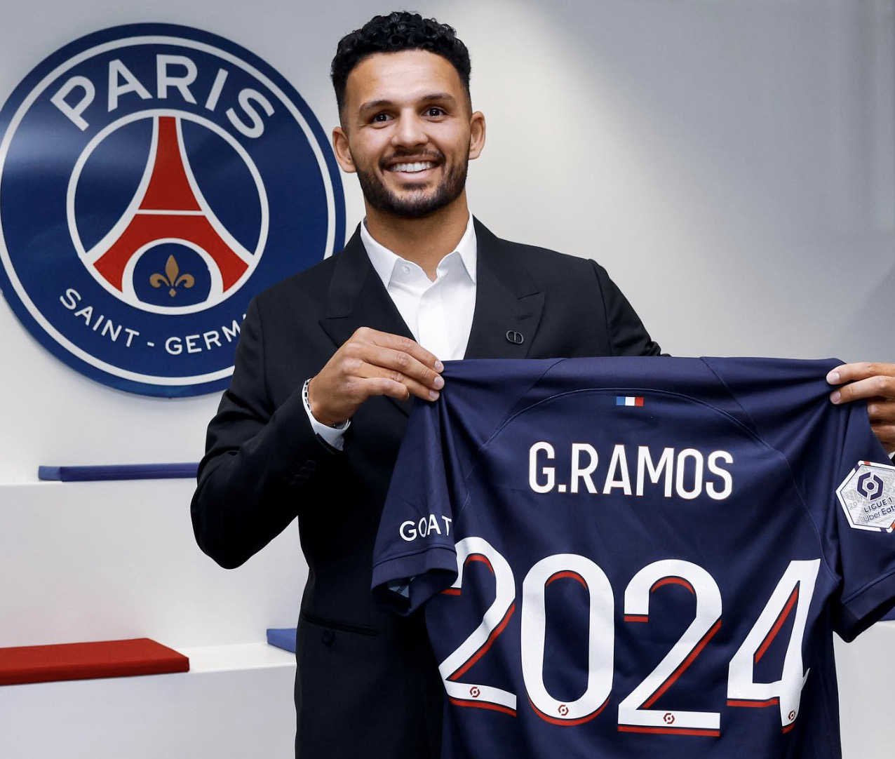 Gonçalo Ramos à sa signature au PSG qui montre le maillot du PSG avec 2024